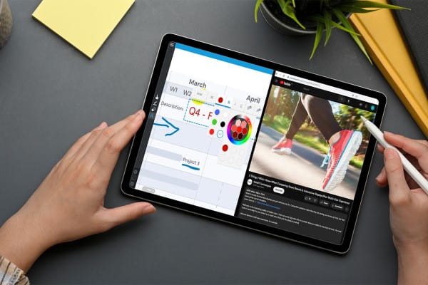 Close-up of hands using a tablet with stylus for graphic design.