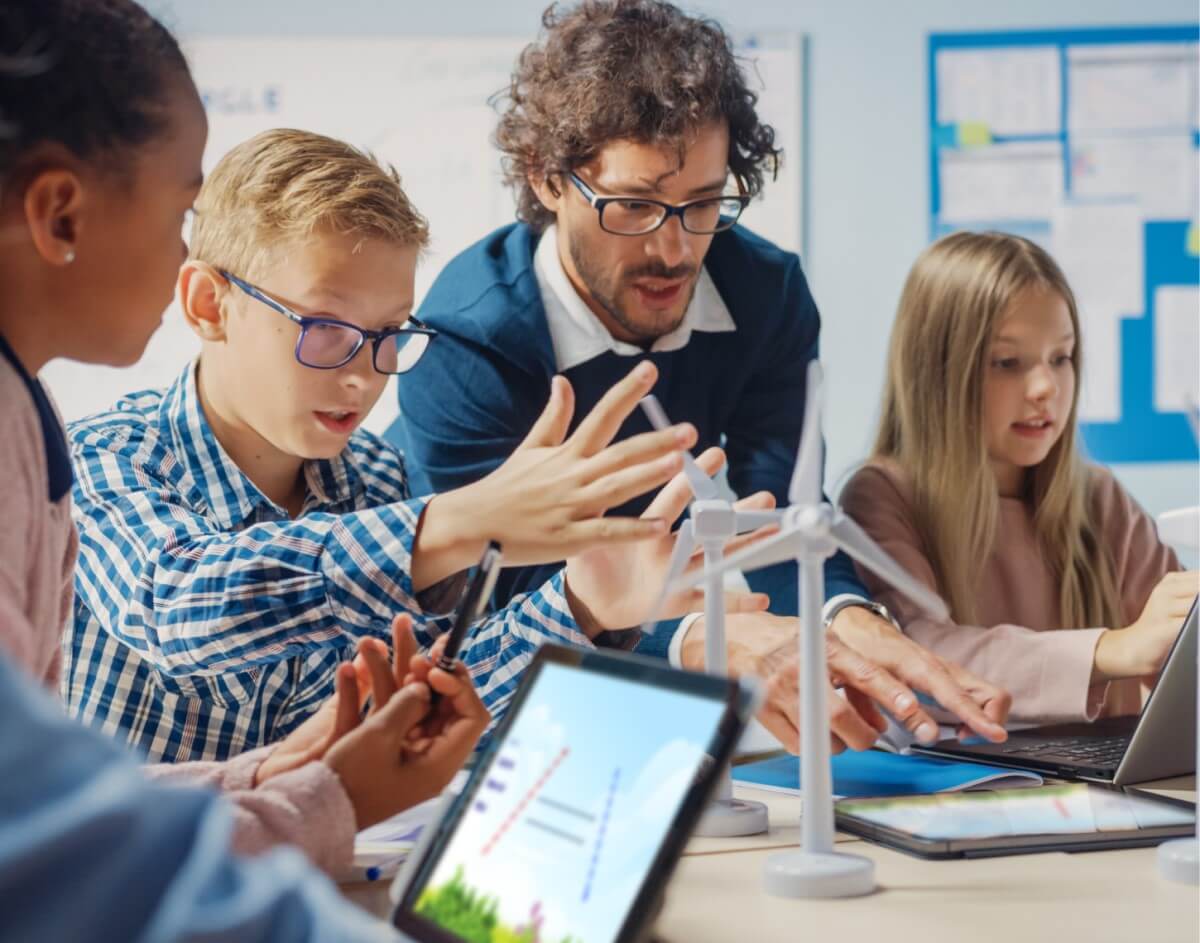 High school students engaging with Lumio interactive lessons on tablets in a collaborative classroom environment.